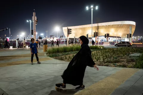 Mundial Qatar 2022: el lado b, en nombre de Dios Qatar: un varón y una nena juegan a la pelota en las inmediaciones de un estadio.
