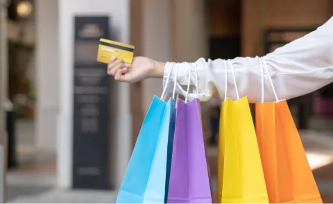 ¿Conviene comprar en Chile?: estos son los precios de las zapatillas, la tecnología y la ropa Una mujer con bolsas de colores en la mano