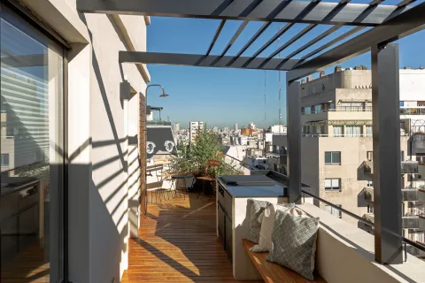 12 buenas ideas para patios, terrazas y balcones Abrieron un balcón cerrado y lo convirtieron en terraza.
