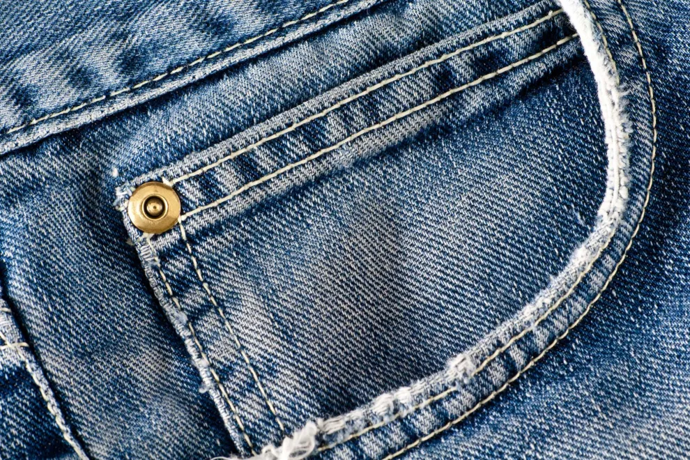 Los botones metálicos cumplen una función fundamental en el armado del jean
