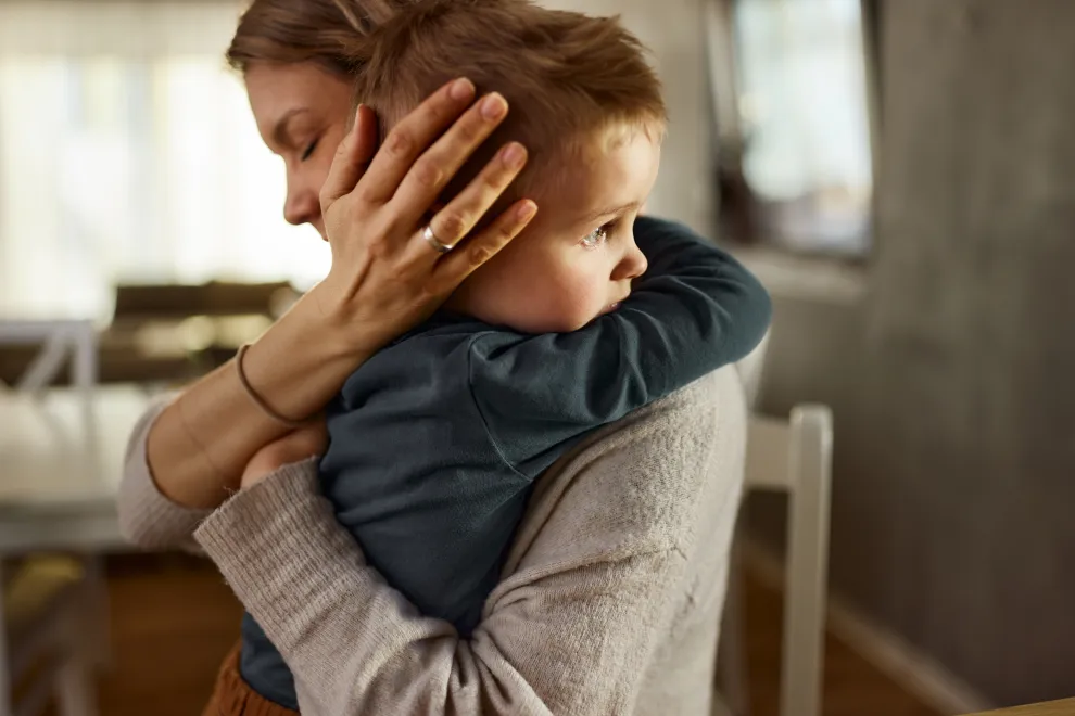 mamá abraza a su hijo pequeño.